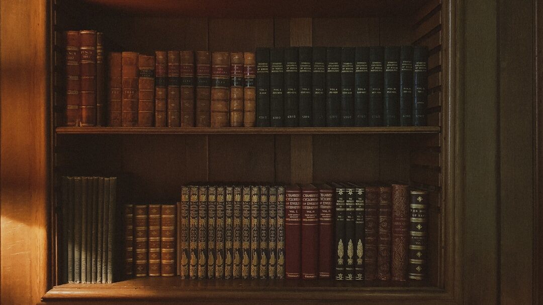 Old wooden bookshelf filled with hardcover novels in warm light