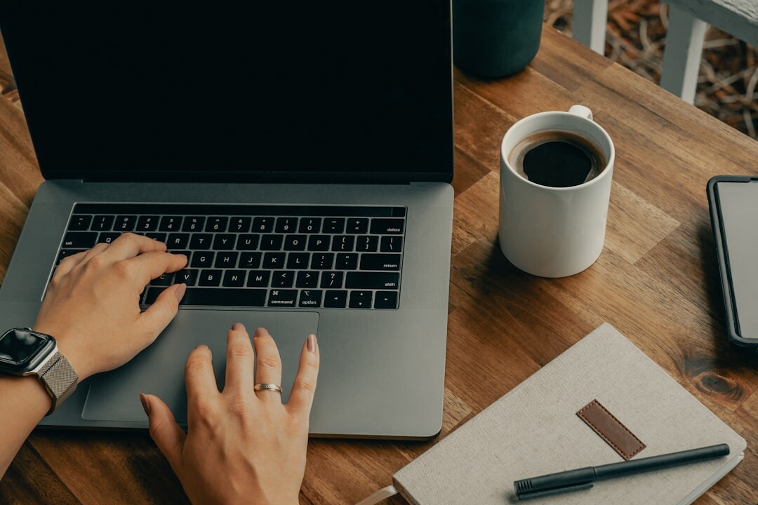 writer typing on laptop