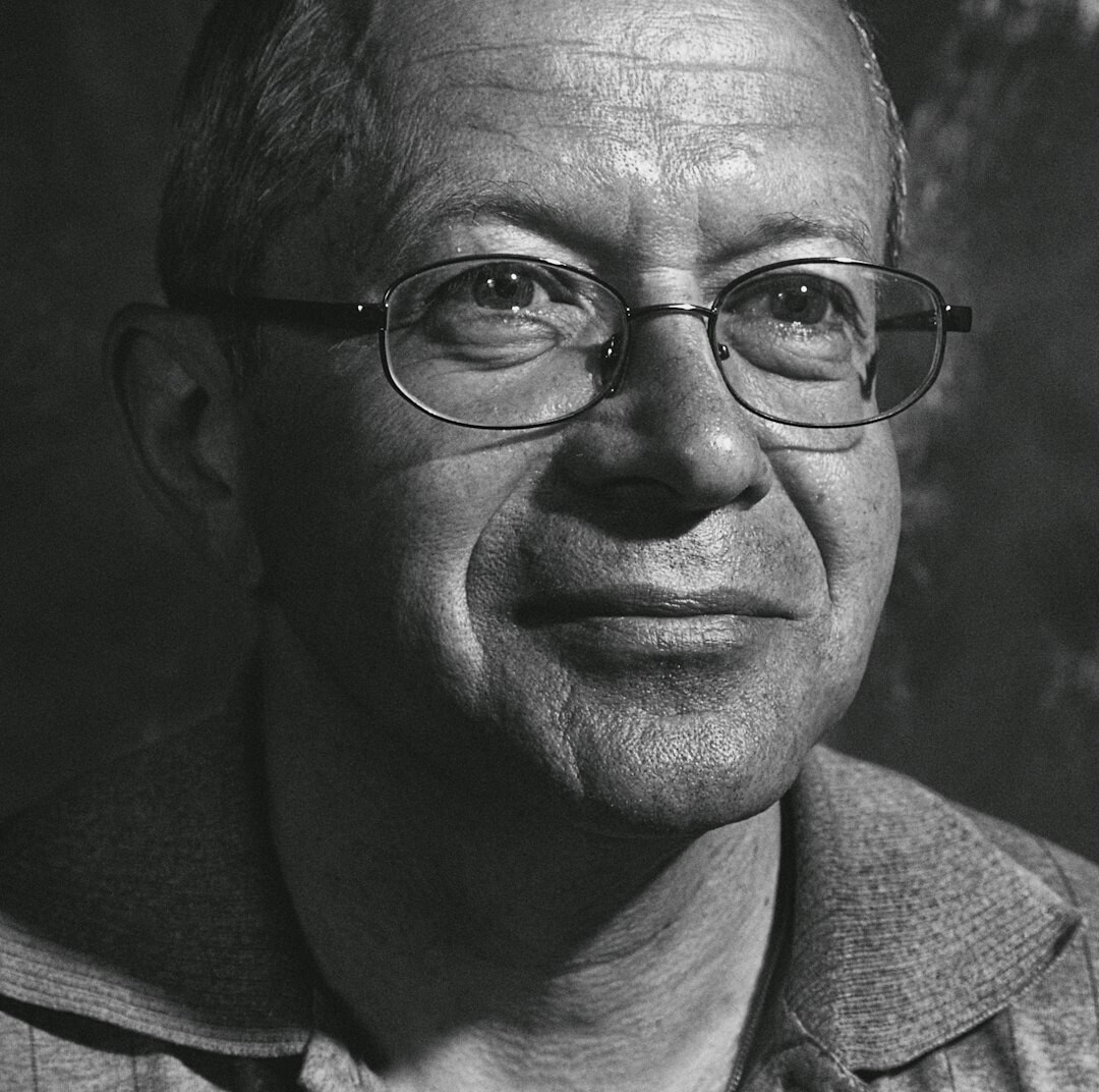 Studio portrait of a middle aged Croatian man with glasses and short hair
